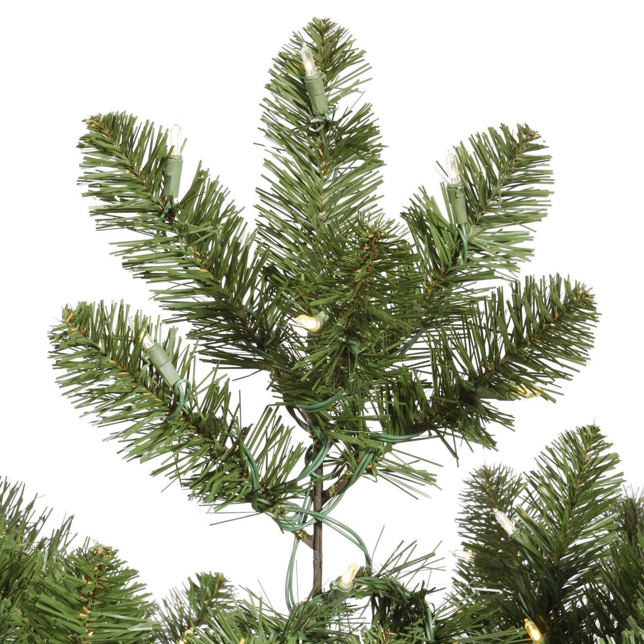 Artificial Christmas tree branch with green needles on a white background