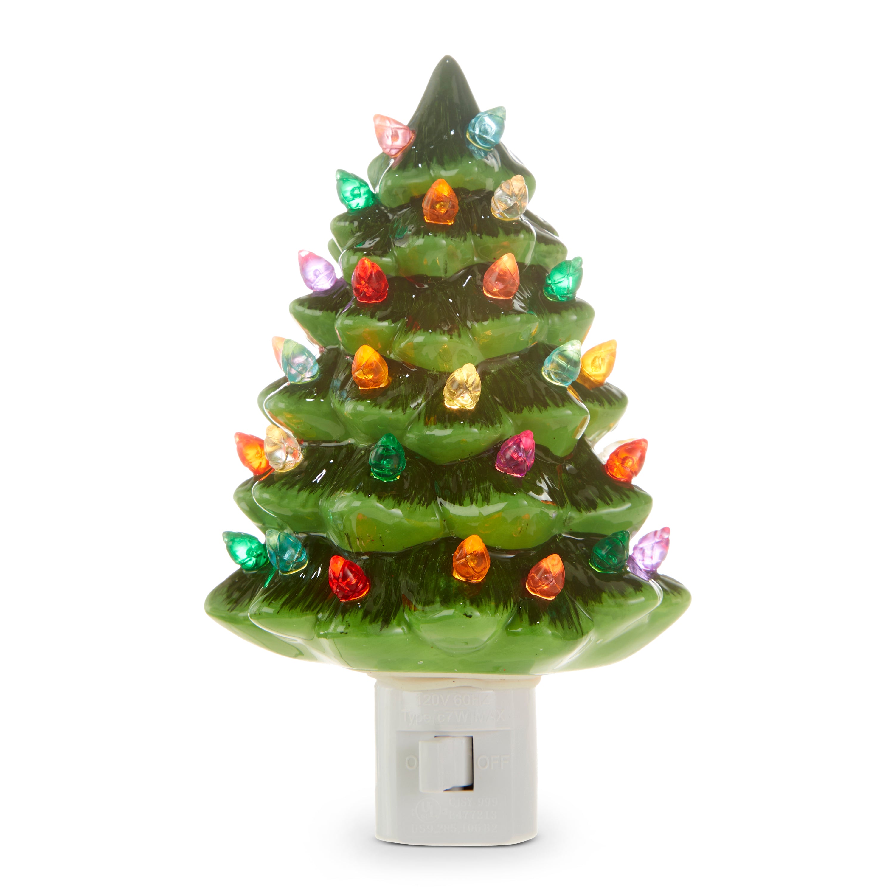 A green ceramic Christmas tree-shaped night light with multicolored lights.