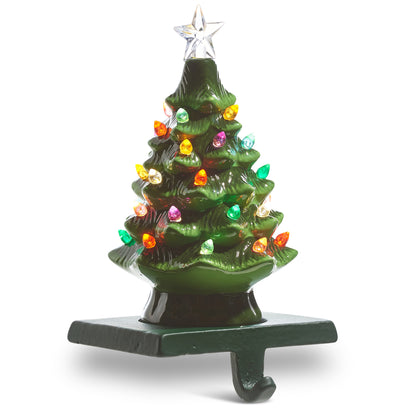 A vintage green lighted ceramic Christmas tree stocking holder with a star at the top and multicolored lights.