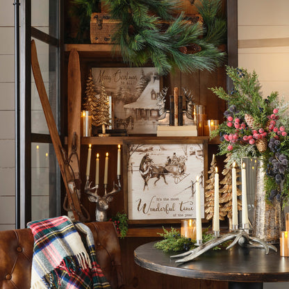 Decorative interior setting with a wooden shelf, candles, and festive decorations.