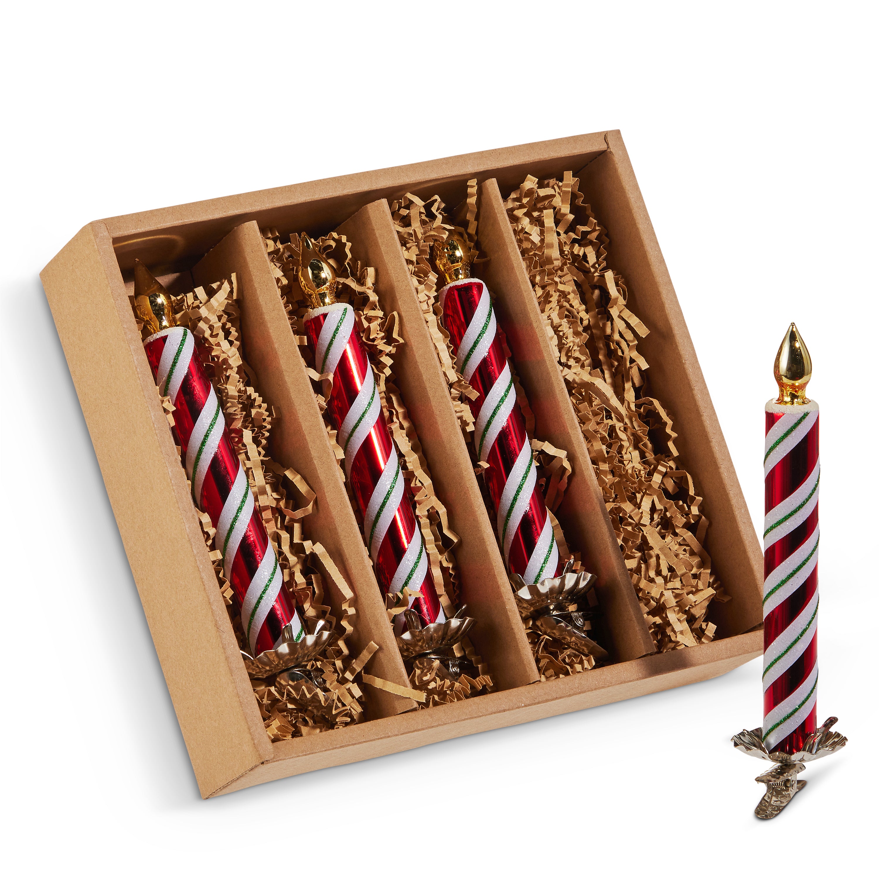 A set of four red and white striped peppermint clip-on candle ornaments displayed in an open box with shredded packing material.