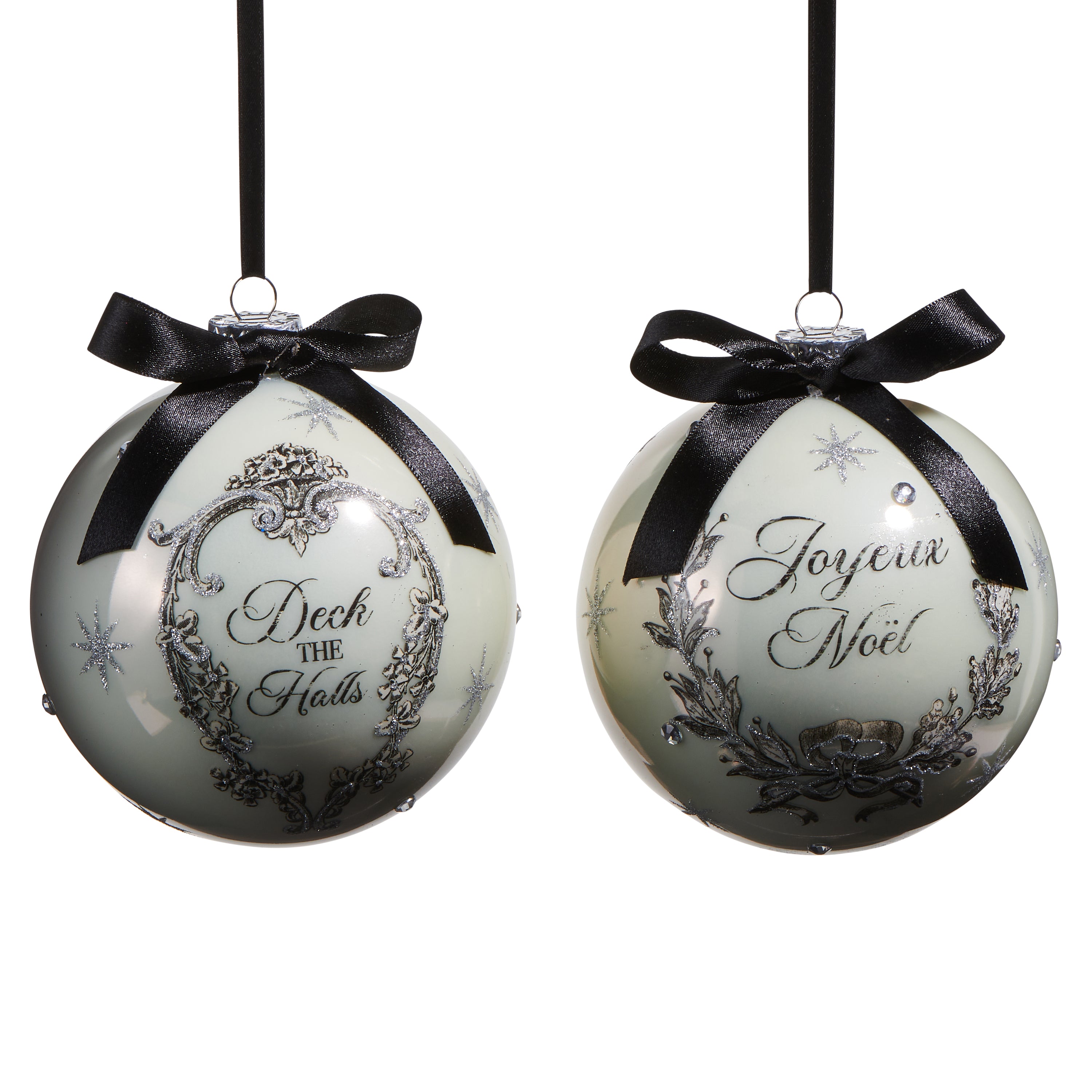 Two round glass Christmas ornaments with bows, one with 'Deck the Halls' and the other with 'Joyeux Noel' written in decorative font, against a white background.