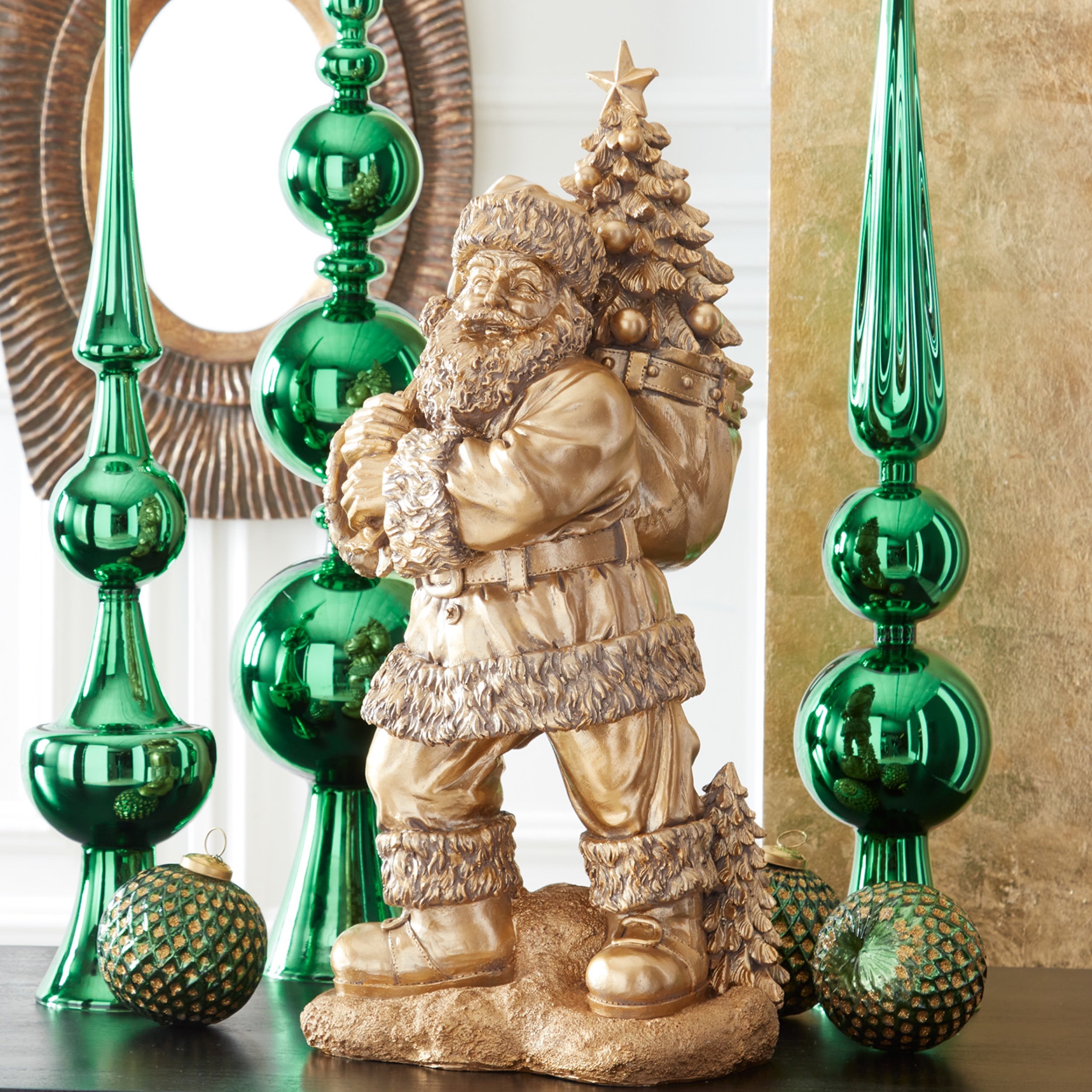 K&K Interiors 23" Antique Gold Resin Santa Claus Statue with Christmas Tree Bag