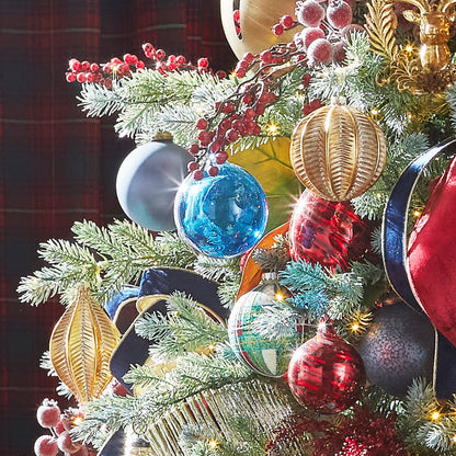 Decorative Christmas tree with colorful ornaments and red berries against a dark background
