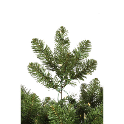 Artificial Christmas tree branch with green needles on a white background