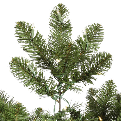 Artificial Christmas tree branch with green needles on a white background