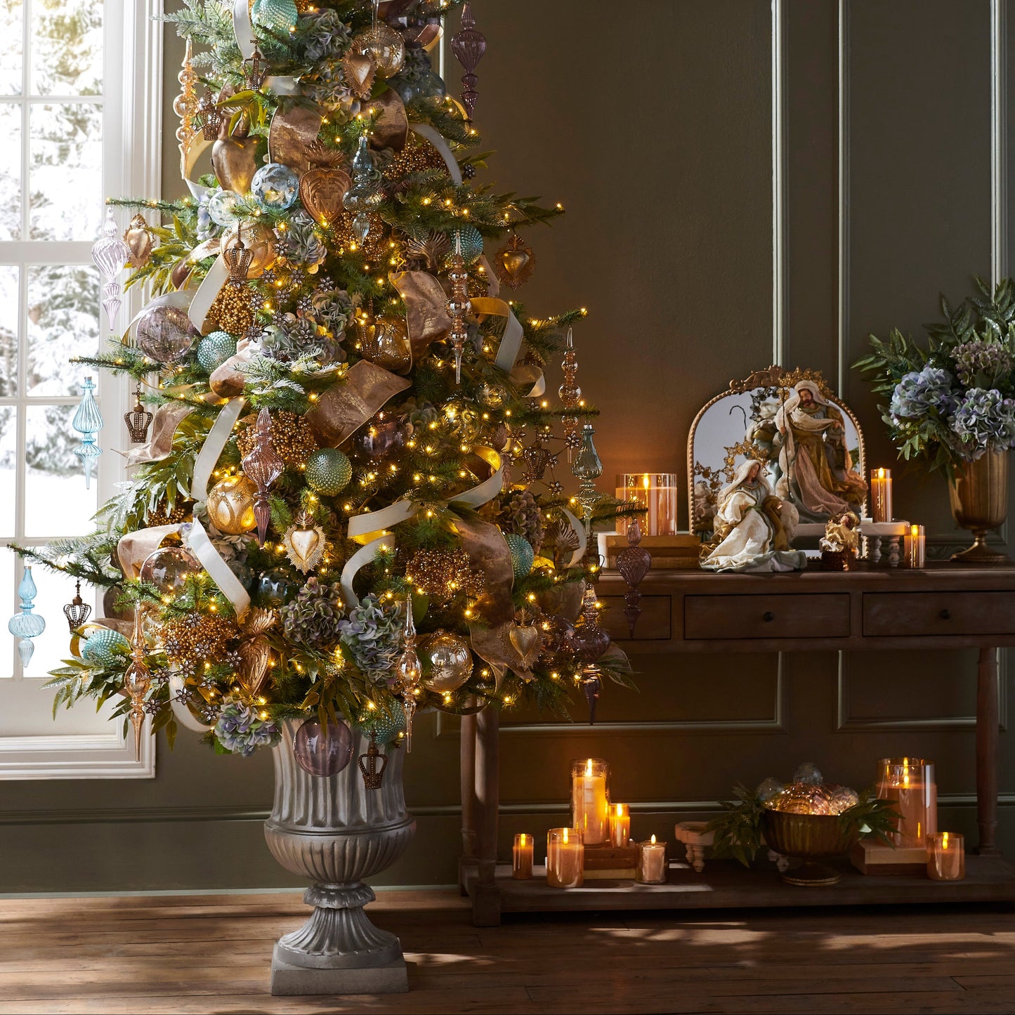 Decorated Christmas tree in a room with candles and a mirror.